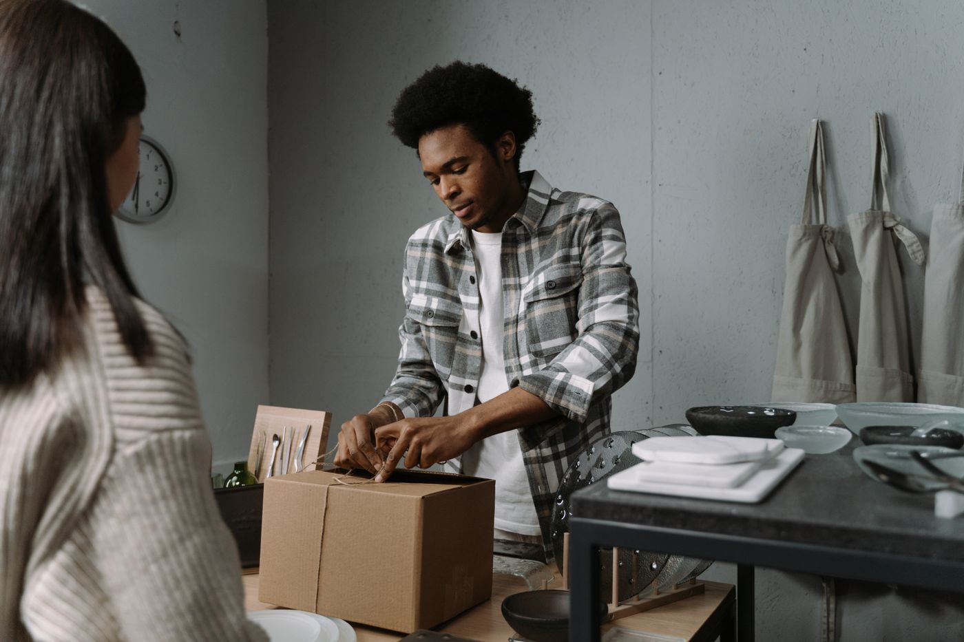 A maker packing an order in a workshop.